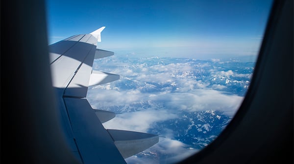 Looking out of a plane window at the clouds