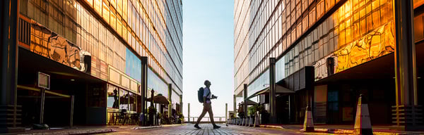 A man in between two glass buildings